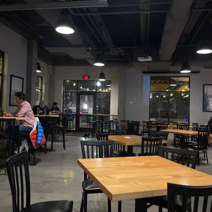 people sitting at tables in a restaurant