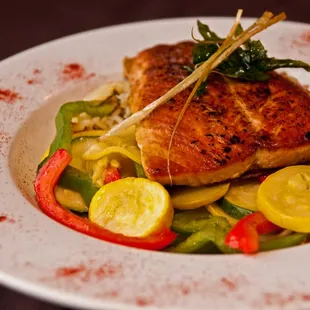 grilled fish and vegetables on a white plate