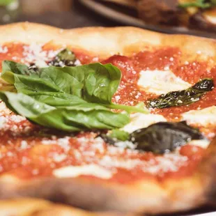 a pizza with spinach and cheese