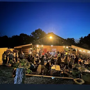 a large group of people sitting outside at night