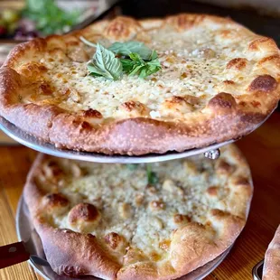 two pizzas stacked on top of each other