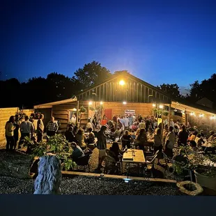 a large group of people sitting outside at night