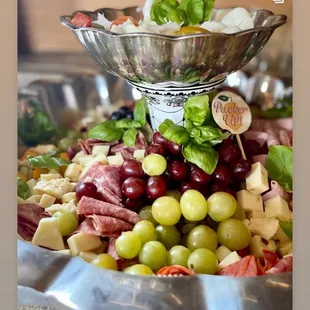 a platter of grapes and meats