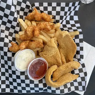 a basket of fried fish and fries