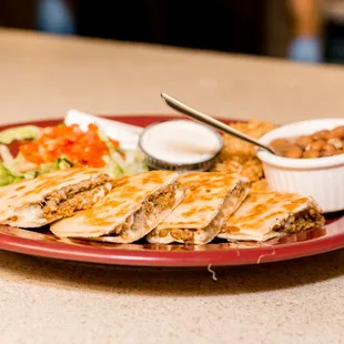 quesadilla meal with rice, beans and other toppings.
