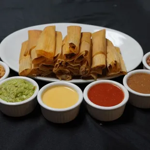 Fresh tamales with rice, beans, and dipping sauces.