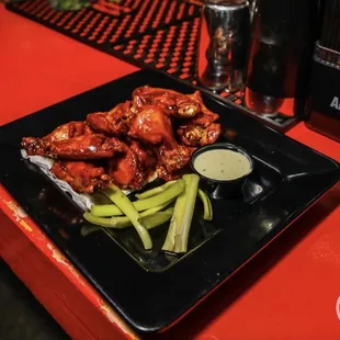 a plate of chicken wings and celery