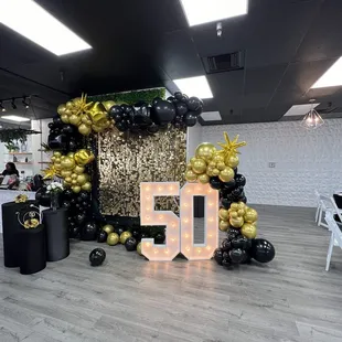 Backdrop custom, table center pieces made  Instragram  @beatrizdecorations   Venue was kind to throw in "50 Sign" for us