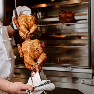 a chef holding a roasting turkey