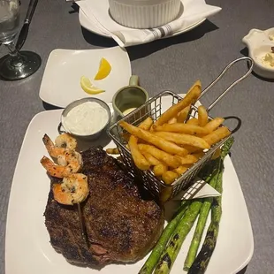 Wet Aged DelMonico Ribeye, shrimp skewer, w/ asparagus and fries.   Cottage Pie