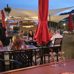 a group of people sitting at a table with wine glasses