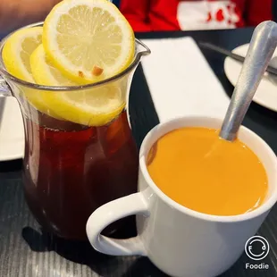 a pitcher of tea and a cup of tea