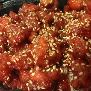 Crispy sesame trio (shrimp, chicken and beef) over a bed of fried rice vermicelli.