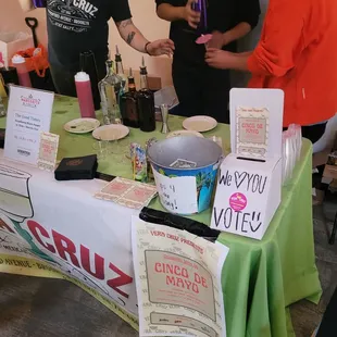 a group of people standing around a table