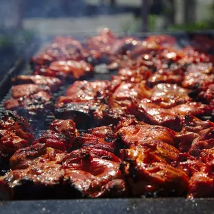 meat being cooked on a grill