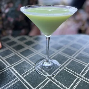 a green drink in a martini glass