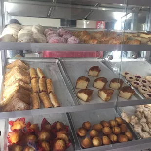 a variety of pastries in a display case