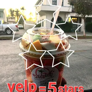 a hand holding a cup of yogurt