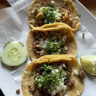 Top to bottom traditional tacos (chicken, carnitas, steak).