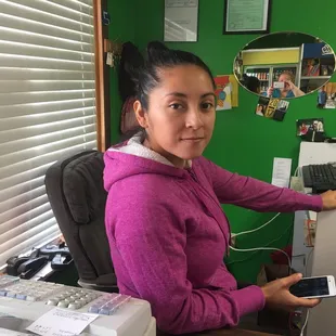 a woman sitting at a desk in front of a computer