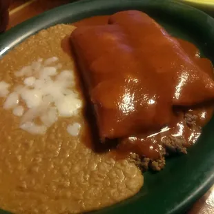 Ground beef enchiladas and beans. Covered in mole sauce? Yuck. C-