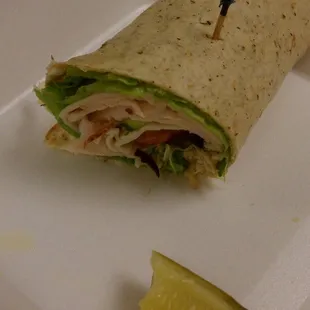 1/2 of my lunch.  Turkey Wrap with cucumber, olives &amp; sprouts....and a wedge of a pickle.