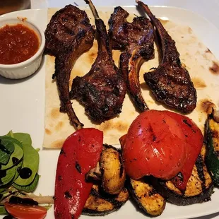 a plate of grilled meat and vegetables