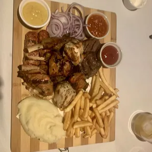 a platter of meat and french fries