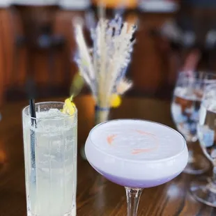 a glass of water and a cocktail on a table