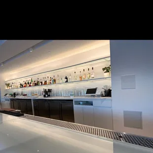 a bar with a lot of bottles on the shelves