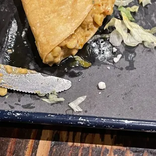 Cream corn and kale taco drenched in oil! You can see the pool of oil beneath the taco.