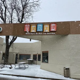 Outside sign on a snowy day.