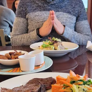 Across the table: carne asada and eggs, chorizo, huevos rojos, me