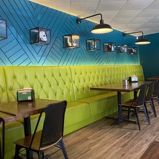 a brightly colored booth with green and blue walls