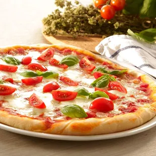 a pizza with tomatoes and basil