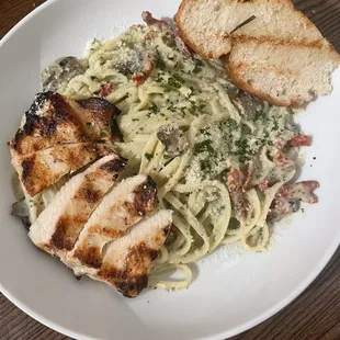 Pesto Chicken (Roasted chicken breast with basil pesto and roasted onions with blistered tomato atop rice pilaf and sauteed spinach)