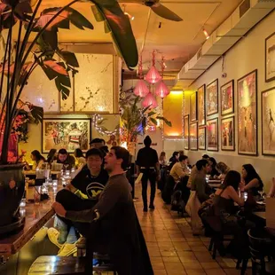people sitting at tables in a restaurant