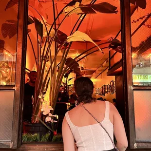 a woman looking out of a restaurant window