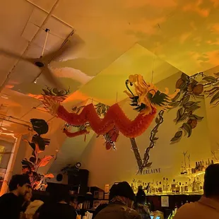 a mural of a dragon in a restaurant