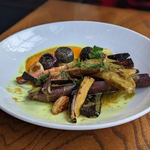 Root vegetable curry with sauce poured tableside