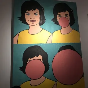 a woman blowing a bubble in front of a painting
