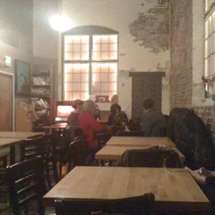A circle of people drinking and playing music.