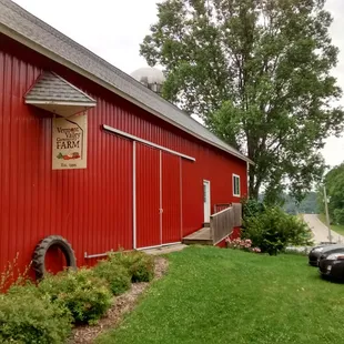 a red barn with a car parked in front of it