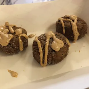 three cookies with peanut butter drizzle