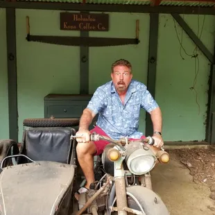 a man sitting on a motorcycle