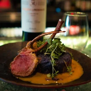 a plate of food and a bottle of wine