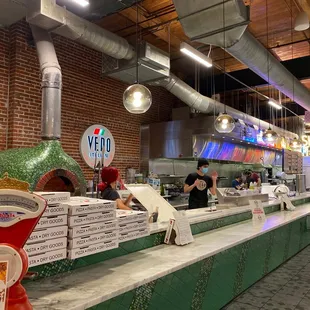 a restaurant counter with a pizza oven