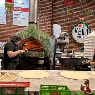 Owner is making his pizza