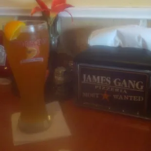 a glass of beer and a napkin dispenser