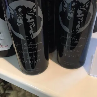 three bottles of wine on a shelf